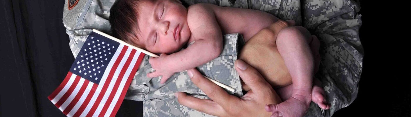 Soldier holding baby in his arms