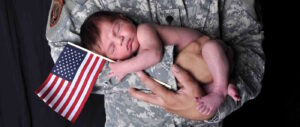 Soldier holding baby in his arms